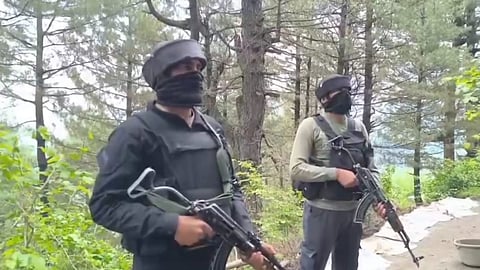 Security personnel stand guard amid an encounter between terrorists and security forces in the Akhal area of Kulgam district, Jammu and Kashmir, Saturday, Aug. 2, 2025.