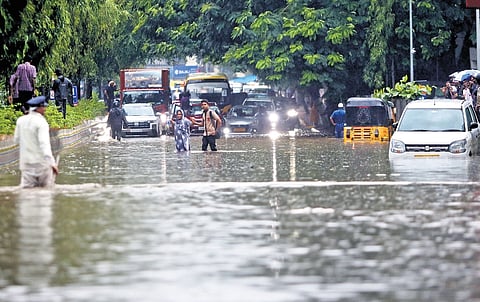 Traffic grinds to a halt on the Raj Bhavan Road which resembles a canal after the rainwater holding structure filled up and overflowed, following the heavy downpour in Hyderabad on Monday.