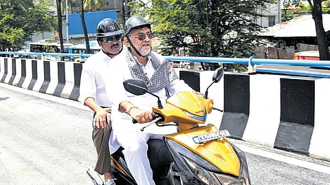 DCM DK Shivakumar rides a two-wheeler with Urban Development Minister Byrathi Suresh as pillion after inspecting Hebbal flyover work on Tuesday