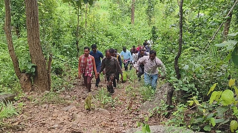 Police investigating team on way to the hilltop where the body was buried