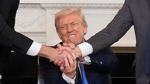 US President Donald Trump, center, shakes hands with Armenian Prime Minister Nikol Pashinyan, right, and Azerbaijan President Ilham Aliyev during a trilateral signing ceremony in the State Dining Room of the White House, Friday, Aug. 8, 2025, in Washington.