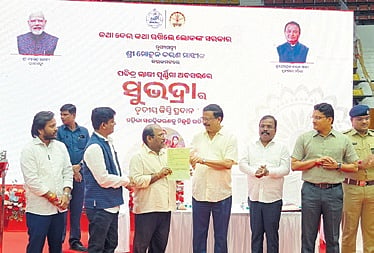 Revenue minister Suresh Pujari handing over RoR to a beneficiary in Cuttack