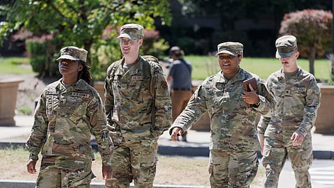Troops depart the District of Columbia National Guard Headquarters as President Donald Trump implements his order to use federal law enforcement and the National Guard to expel homeless people, in Washington, Tuesday, Aug. 12, 2025.