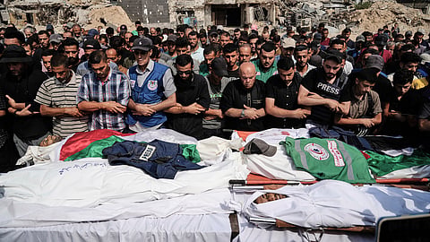 Palestinians pray over the bodies of journalists, including Al Jazeera correspondents Anas al-Sharif and Mohamed Qreiqeh, who were killed in an Israeli airstrike, during their funeral outside Gaza City's Shifa hospital complex, Monday, Aug. 11, 2025.