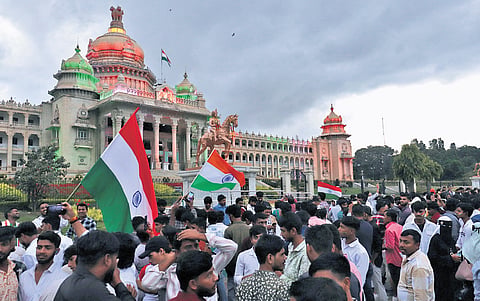 A huge crowd celebrates in front of Vidhana Soudha.