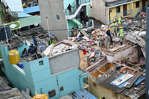 SDRF personnel and firefighters inspect the blast site in Wilson Garden, Bengaluru, on Friday