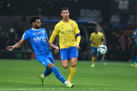 Al Nassr's Cristiano Ronaldo, right, and Al Hilal's Al Bulayhi challenge for the ball during Riyadh Season Cup 2024 final match at the Kingdom Arena Stadium in Riyadh, Saudi Arabia, Thursday, Feb. 8, 2024.