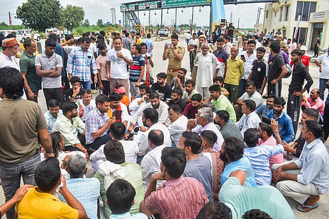 Meerut: People stage a protest near Bhuni toll plaza after an Indian Army jawan was allegedly assaulted by the toll plaza employees, in Meerut district, Uttar Pradesh, Monday, Aug. 18, 2025.