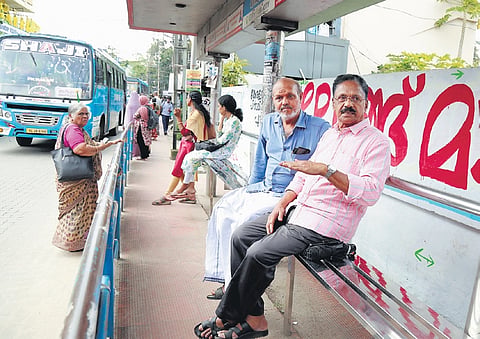 Consumer rights activist Tilakan and ward councillor C Nandakumar at a Kodungallur bus stand with newly-installed seating.
