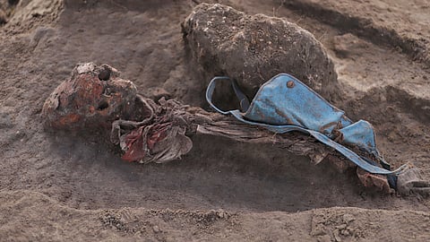 An exhumed human skeleton is seen with a school bag at the site of a mass grave in Chemmani, Sri Lanka, June 28, 2025.