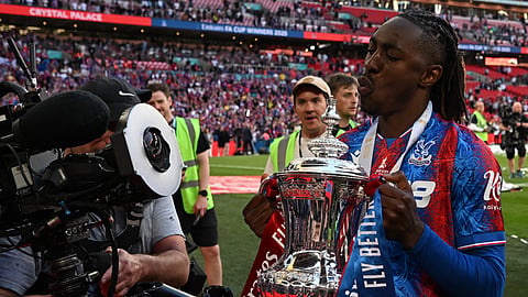Crystal Palace's English midfielder Eberechi Eze poses with the trophy after the English FA Cup final football match between Crystal Palace and Manchester City at Wembley stadium in London, on May 17, 2025.