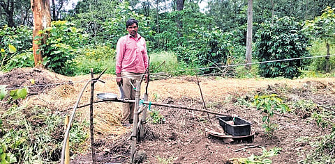 Sreeraman with the water-powered device he had developed to deter animals