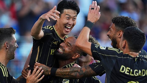 Los Angeles FC forward Heung Min Son, top, celebrates with teammates after scoring during the first half of an MLS soccer match against FC Dallas in Frisco, Texas, Saturday, Aug. 23, 2025.