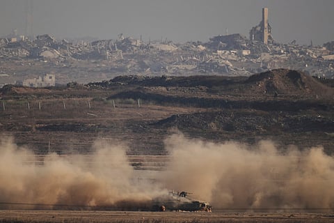 An Israeli armoured personnel carrier (APC) moves through the Israeli-Gaza border, as seen from southern Israel, Monday, Aug. 25, 2025.