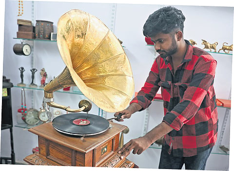 A man works on a gramophone at his shop in the Old City of Hyderabad