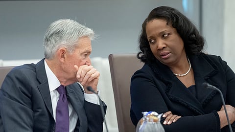 US Federal Reserve Chairman Jerome Powell, left, talks with Board of Governors member Lisa Cook, right, during an open meeting of the Board of Governors at the Federal Reserve, June 25, 2025, in Washington.