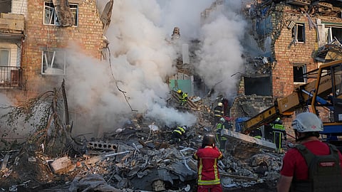 Firefighters work at the site of a burning building after a Russian attack in Kyiv, Ukraine, Thursday, Aug. 28, 2025.