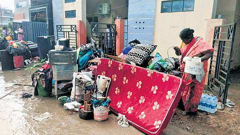 Flood-hit residents clean their homes in GR Colony, Kamareddy on Friday