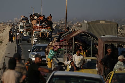 Displaced Palestinians fleeing northern Gaza Strip move with their belongings along the Sea Road, near Wadi Gaza, Saturday, Aug. 30, 2025.