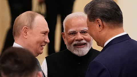 Russian President Vladimir Putin, from left, Indian Prime Minister Narendra Modi and Chinese President Xi Jinping talk ahead of the Shanghai Cooperation Organization (SCO) summit at the Meijiang Convention and Exhibition Center in Tianjin, China, Monday, Sept. 1, 2025.
