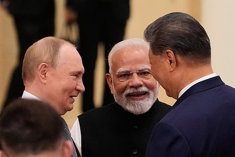 Russian President Vladimir Putin, from left, Indian Prime Minister Narendra Modi and Chinese President Xi Jinping talk ahead of the Shanghai Cooperation Organization (SCO) summit at the Meijiang Convention and Exhibition Center in Tianjin, China, Monday, Sept. 1, 2025.