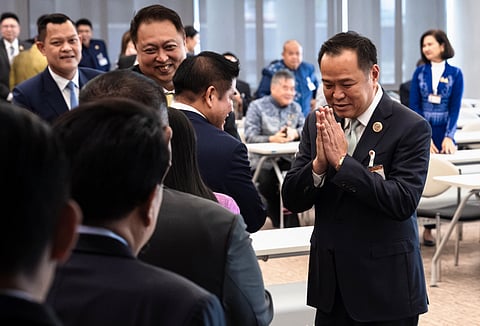 Bhumjaithai Party leader Anutin Charnvirakul (R) greets fellow MPs at the parliament in Bangkok on September 3, 2025.