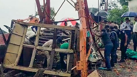 Officials and others stand near the site where the cable wire of a cargo ropeway snapped, killing at least six people, at the Pavagadh Hill temple, in Panchmahal district, Gujarat, Saturday, Sept. 6, 2025.