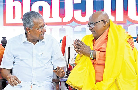 Sivagiri Mutt head Swami Satchidananda greets Chief Minister Pinarayi Vijayan during the 171st Sree Narayana Guru birth anniversary celebrations at Chempazhanthy in Thiruvananthapuram on Sunday.