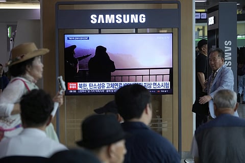 A TV screen shows an image of North Korean leader Kim Jong Un, second from right, supervising a test of a new rocket engine during a news program at the Seoul Railway Station in Seoul, South Korea, Tuesday, Sept 9, 2025