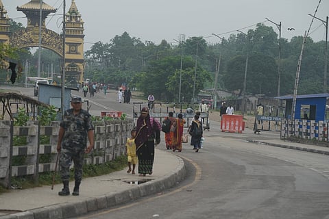 People move past a security check post in the wake of violent protests that erupted in Kathmandu, near the India-Nepal border, in Raxaul, Bihar, Wednesday, Sept. 10, 2025.