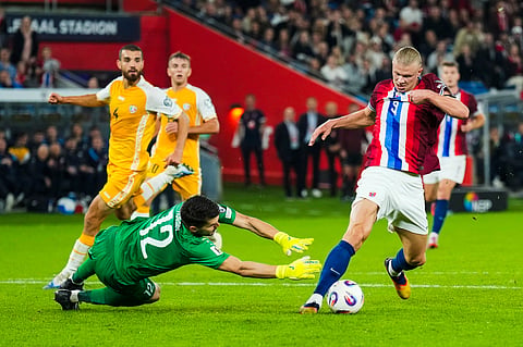 Norway's Erling Haaland, right, gets past Moldova goalkeeper Cristian Avram before scoring his fourth goal of the game during the World Cup qualifying soccer match between Norway and Moldova on Tuesday Sept. 9, 2025.