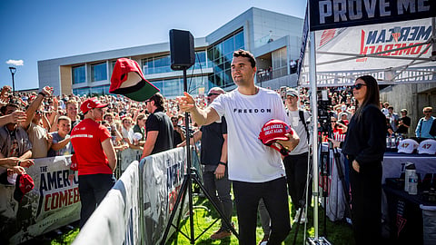 Charlie Kirk hands out hats before speaking at Utah Valley University in Orem, Utah, Wednesday, Sept. 10, 2025.