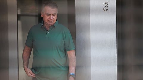Brazil's former President Jair Bolsonaro stands at the entrance of his home where he is under house arrest in Brasilia, Brazil, Thursday, Sept. 11, 2025.