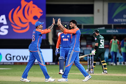 Axar Patel (R) celebrates a wicket with captain Suryakumar Yadav on Sunday