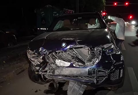 Wreckage of a BMW car lies on a road after an accident in New Delhi, Sunday, Sept. 14, 2025.
