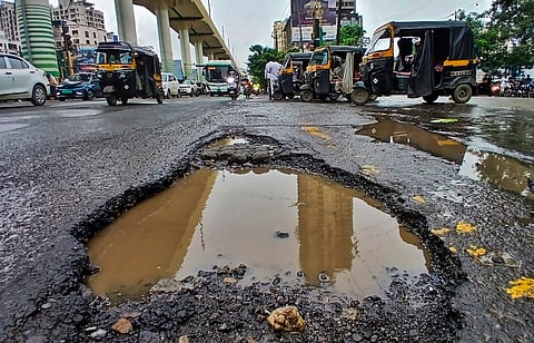 A view of waterlogged potholes on Ghodbunder Road, in Thane, Maharashtra, Tuesday, Sept. 16, 2025.