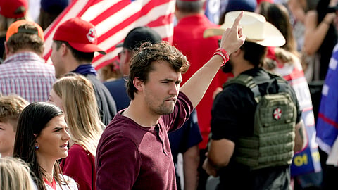 Charlie Kirk, conservative activist and founder of Turning Point USA, walks through the crowd at a pro-Trump rally outside the Maricopa County Recorder's Office where elections officials continue to count ballots, Friday, Nov. 6, 2020, in Phoenix.