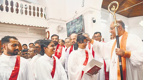 Bishop Dr Royce Manoj Victor of the Malabar diocese blesses Dr Saju Mary Abraham and Nimshi David, the first women ordained as deacons in the diocese, at a ceremony at the CSI Cathedral, Mananchira, Kozhikode