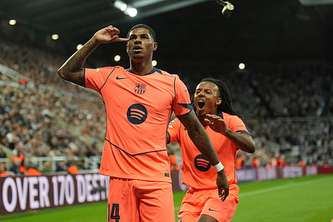 Barcelona's Marcus Rashford, left, celebrates after scoring his side second goal with Jules Kounde during the Champions League, opening phase soccer match between Newcastle and Barcelona.