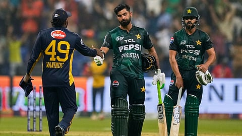 Pakistan's Hussain Talat shakes hands with Sri Lanka's Wanindu Hasaranga after winning the Asia Cup cricket match between Pakistan and Sri Lanka at Zayed Cricket Stadium in Abu Dhabi, United Arab Emirates, Tuesday, Sept. 23, 2025.