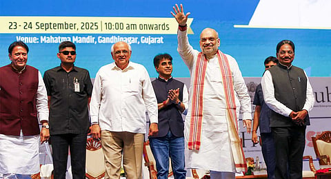 Union Home Minister Amit Shah waves to the gathering as Gujarat Chief Minister Bhupendra Patel looks on during the state's 'Startup Conclave 2025', in Gandhinagar, Gujarat, Tuesday, Sept. 23, 2025.