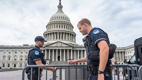 Capitol Police officers adjust security barriers around the East Plaza at the Capitol in Washington, Wednesday, Sept. 24, 2025.