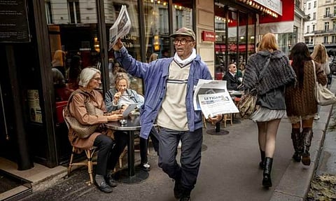 Pakistani born 73-year-old newspaper hawker Ali Akbar sells newspaper copies in the street of the Latin Quarter in Paris on September 16, 2025. Akbar, the last remaining newspaper vendor of the French capital, will be awarded by France's President as knight in the National Order of Merit.