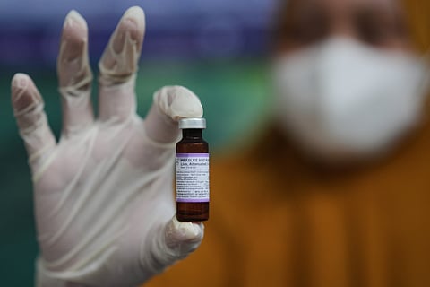 A health worker shows a vial of measles-rubella vaccine during a vaccination campaign in Sumenep on Madura Island, Indonesia, Monday, Sept. 8, 2025.