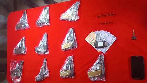 The guns and cash seized by the police from Shaikh Nadeem.