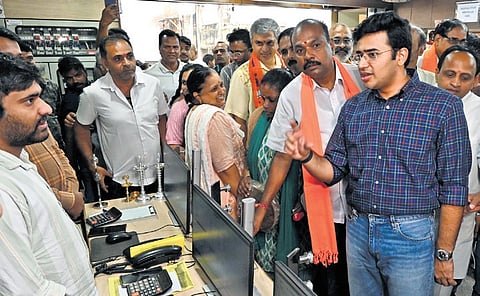 Bengaluru South MP Tejasvi Surya interacts with a shop vendor to gauge the impact of GST reforms on sales, in Nagarathpet on Saturday