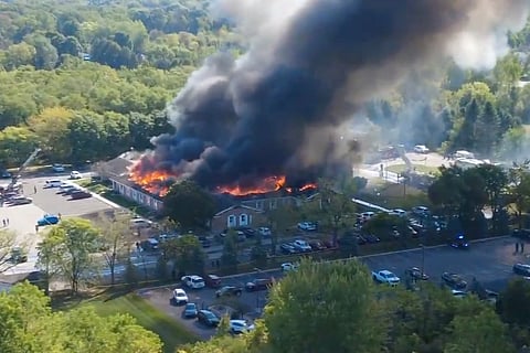 Massive flames and smoke rise from The Church of Jesus Christ of Latter-day Saints in Grand Blanc, about 50 miles north of Detroit, Sunday, Sept. 28, 2025.