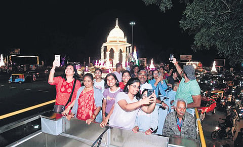 People enjoy their ride and click pictures on the upper deck of the Ambaari service in Mysuru on Sunday