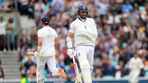 England's Chris Woakes, right, runs between the wickets with his arm in a sling after a shoulder injury earlier in the match on day five of of the fifth cricket test match between England and India at the Kia Oval in London, Monday, Aug 4, 2025.