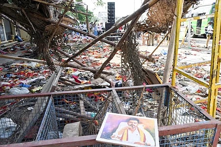 Party flag and chappels remain after the rampage at TVK leader campaign rally in Karur on Sunday